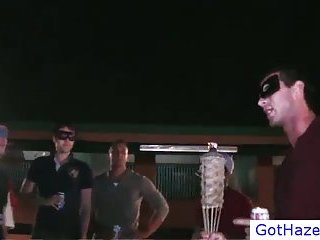 Blindfolded guys hazing outdoors